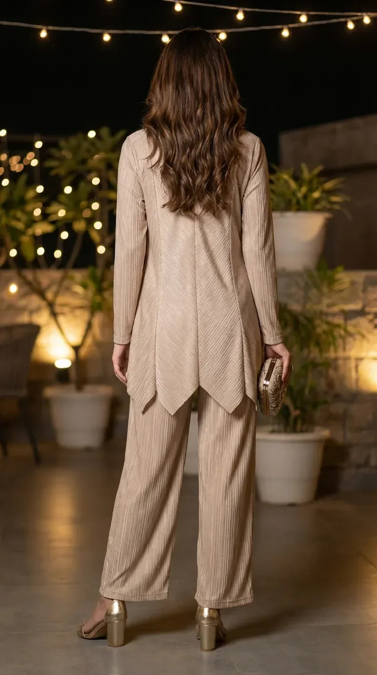 Woman wearing beige shimmer zigzag co-ord set from Karchobi, evening outdoor setting