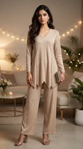 Woman wearing a beige shimmer zigzag co-ord set from KARCHOBI, styled in a chic living room.
