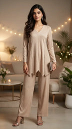 Woman wearing a beige shimmer zigzag co-ord set from KARCHOBI, styled in a chic living room.