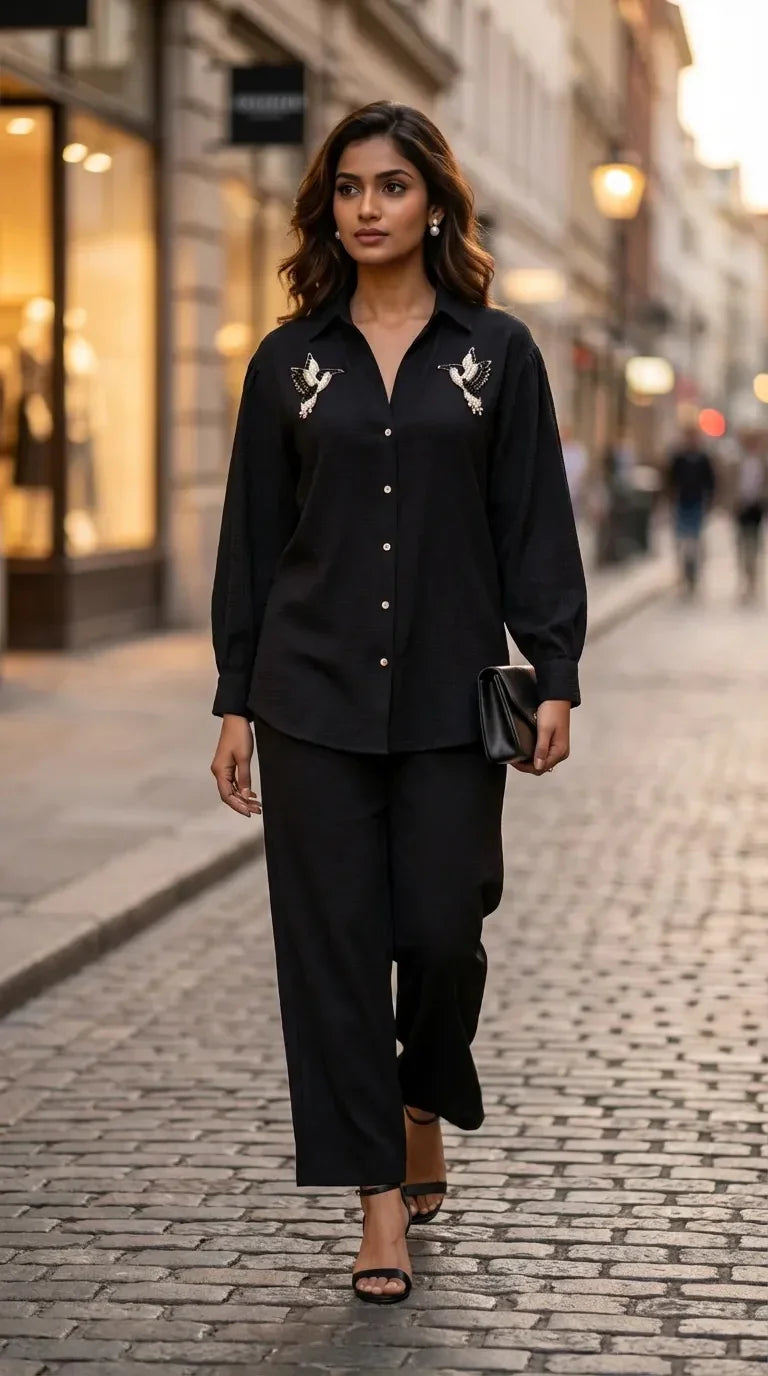 Woman in Karchobi black shirt co-ord set with bird motif, stylish street fashion