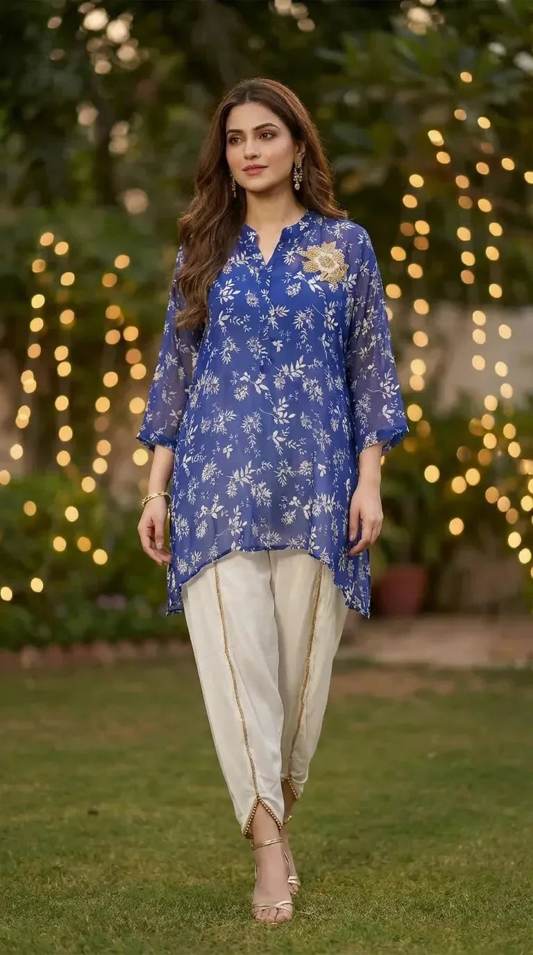 Woman wearing a blue floral print kaftan shirt and white dhoti set by Karchobi outdoors