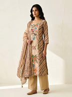 Beige chanderi cotton suit set by Karchobi featuring floral embroidery, bird motifs, subtle French knots, kurta, pant, and dupatta.