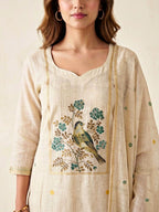 Beige and green Chanderi cotton suit set with woven bird and floral motifs, includes kurta, churidar, and dupatta by KARCHOBI.