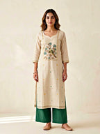 Beige and green chanderi cotton suit set with woven bird and floral motifs, includes kurta, pants, and dupatta.