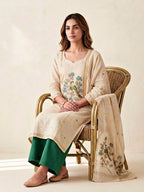 Beige and green chanderi cotton suit set with woven bird and floral motifs, includes kurta, pants, and dupatta by Karchobi.