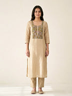 Beige chanderi cotton suit set with paisley embroidery, featuring kurta, pants, and embroidered dupatta from Karchobi.