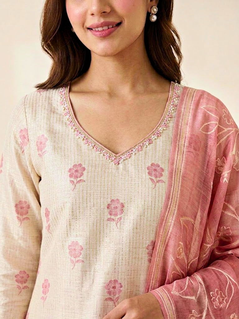 Ivory and pink chanderi suit set with floral print, gold zari embroidery, woven dupatta, kurta, and matching pants.