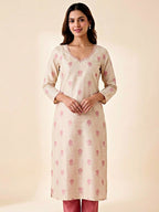 Ivory and pink Chanderi suit set with floral print, gold zari embroidery, woven dupatta, and matching kurta and pants.