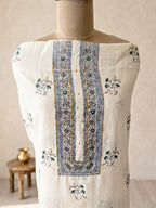 Off-white cotton linen unstitched suit set with floral paisley prints, includes kurta, pants, and dupatta.