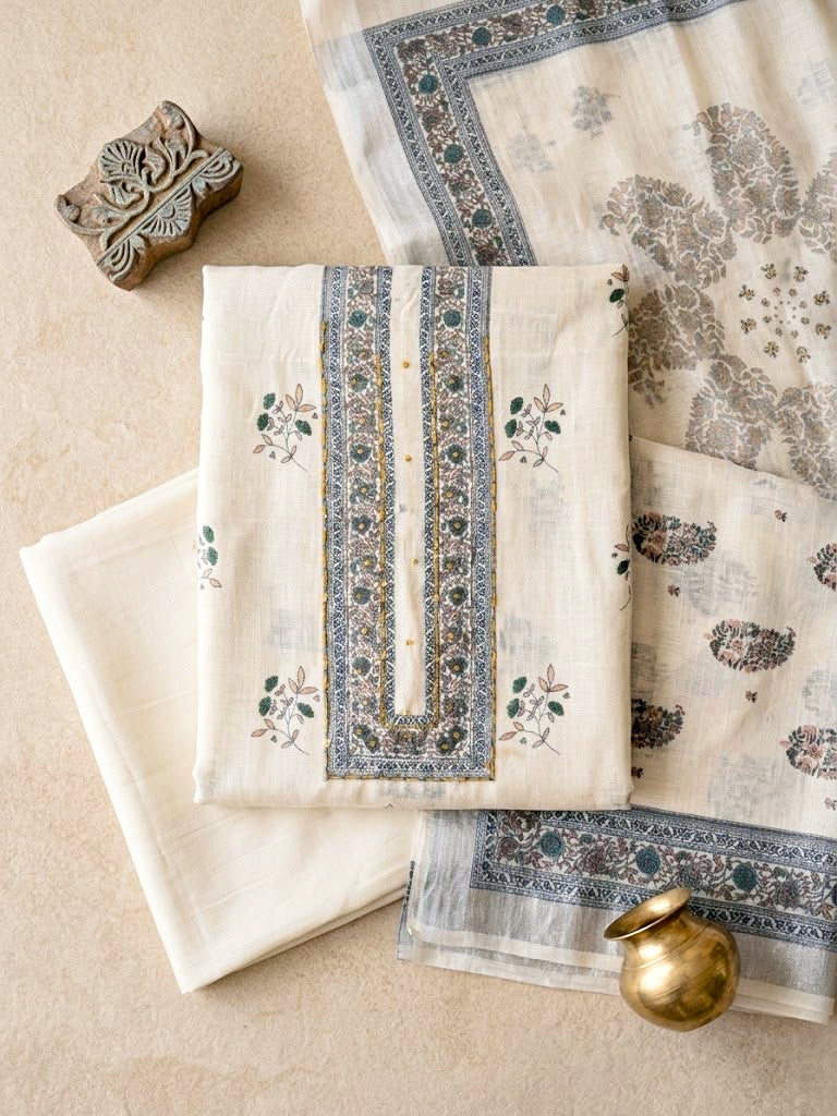 Off-white cotton linen unstitched suit set with floral paisley prints, includes kurta, pants, and dupatta by Karchobi.