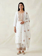White cotton linen cross stitch embroidery suit set with kurta, pants, and dupatta by Karchobi, showcasing detailed traditional design.