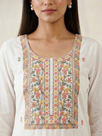White cotton linen suit set with cross-stitch embroidery, includes kurta, pants, and dupatta, by Karchobi.
