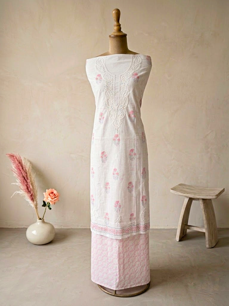 White cotton block print unstitched suit set featuring floral design with kurta, pants, and dupatta for women.