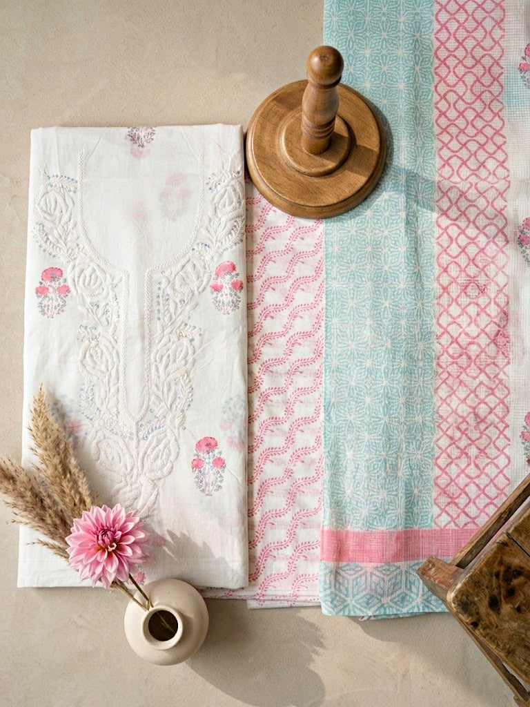White cotton block print unstitched suit set with floral design, includes kurta, pants, and dupatta for casual or work wear.