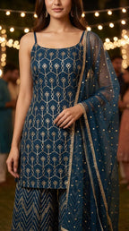 Woman wearing dark teal blue kurta sharara set with gota pattern embroidery from Karchobi.