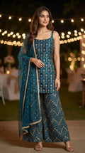 Woman wearing dark teal blue kurta sharara set with gota embroidery from Karchobi