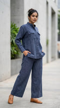 Woman wearing Karchobi denim blue check Mandarin collar shirt and co-ord set outdoors