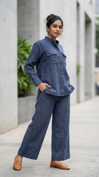 Woman wearing Karchobi denim blue check Mandarin collar shirt and co-ord set outdoors