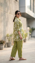 Woman in a green floral Karchobi kaftan co-ord set with shirt and pant, outdoor setting