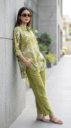 Woman wearing Karchobi green printed kaftan shirt and pants co-ord set, outdoor setting