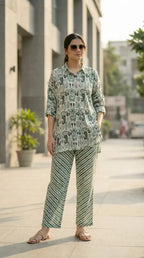 Woman wearing Karchobi green paisley print kaftan shirt and striped co-ord set outdoors