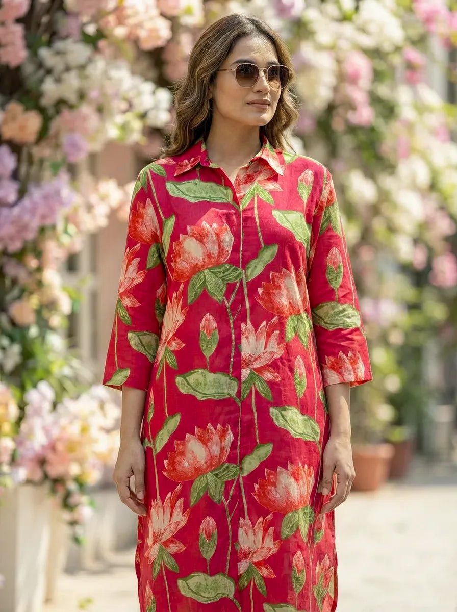 Woman wearing a hot pink red floral kurta coord set with a blurred floral background
