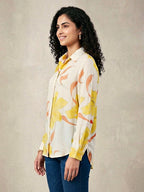 Ivory and yellow floral crepe shirt by KARCHOBI featuring pastel floral print, casual work wear style, long sleeves, and collar.
