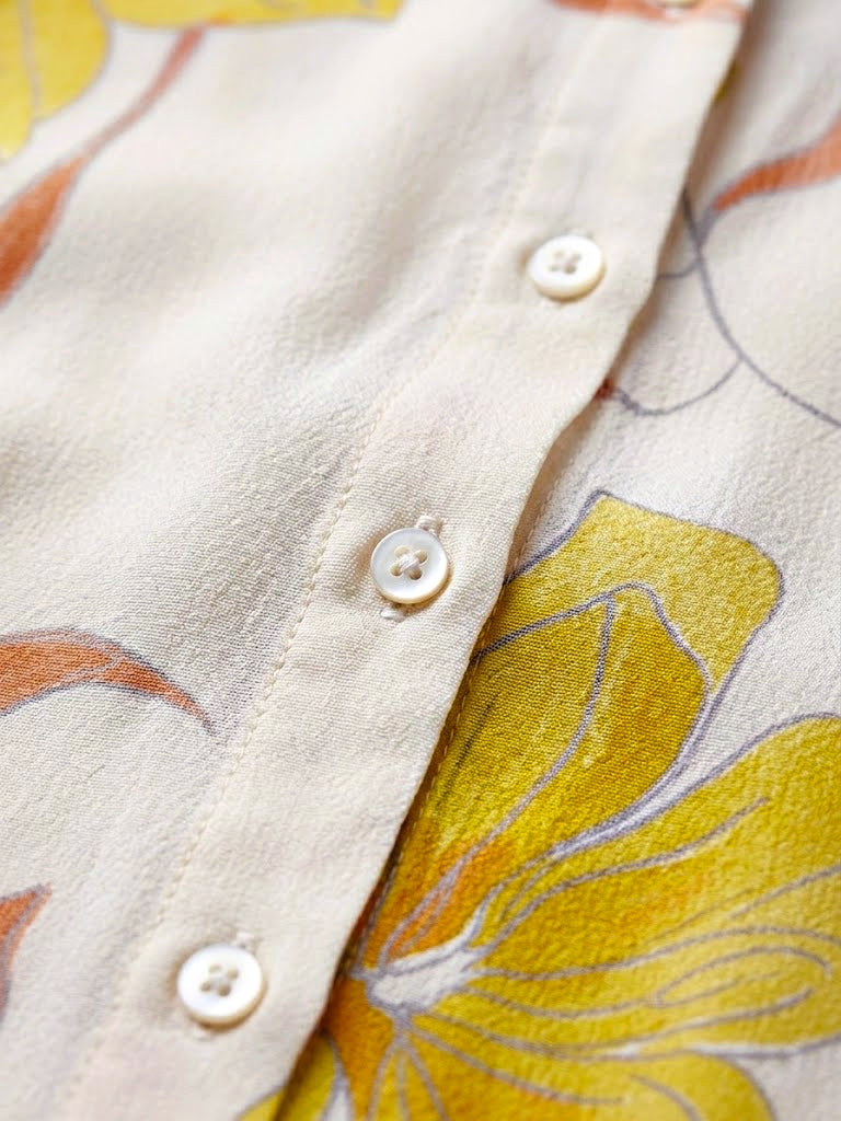 Ivory and yellow floral crepe shirt by KARCHOBI with pastel floral print, casual workwear style, long sleeves, and button front.