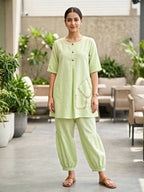 Karchobi Lemon Green linen slub co-ord set with jute lace trim, featuring pleated Afghani salwar and casual wear style.