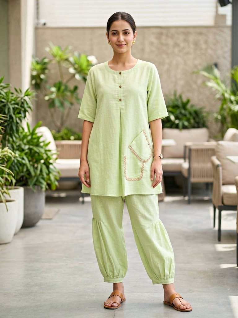 Karchobi Lemon Green linen slub co-ord set with jute lace trim, featuring pleated Afghani salwar and casual wear style.