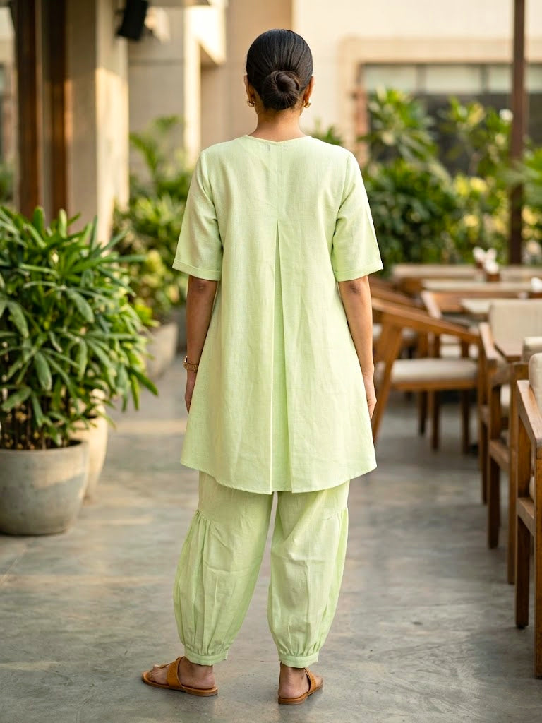 Lemon green linen slub co-ord set with jute lace trims and pleated Afghani salwar, casual wear by KARCHOBI.