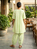 Lemon green linen slub co-ord set with jute lace trims and pleated Afghani salwar, casual wear by KARCHOBI.