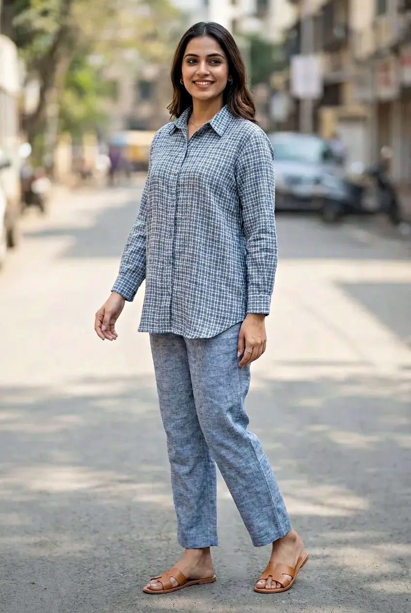 Woman wearing a light blue checkered coord set outfit on a street