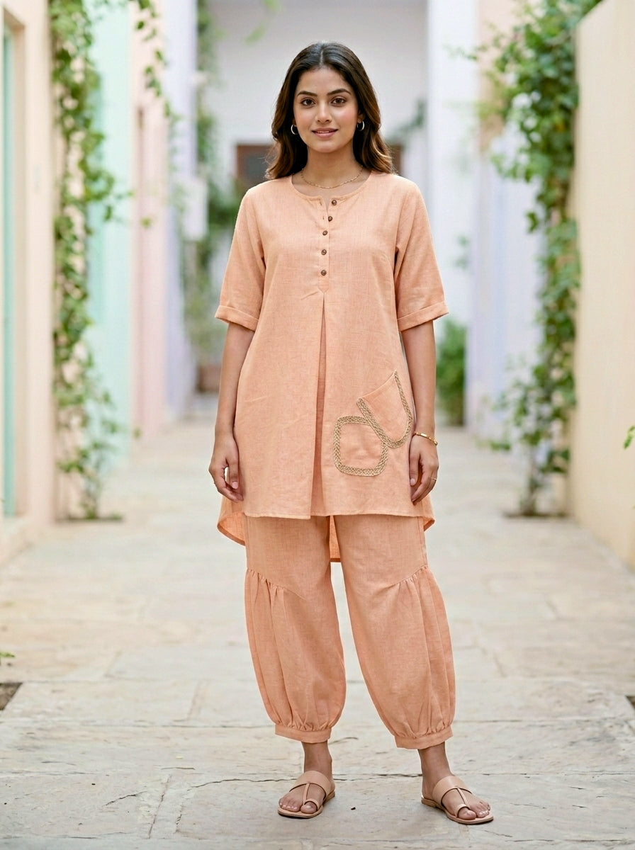 Light peach orange Karchobi Afghani salwar co-ord set featuring a cotton-linen kurta and matching trousers.