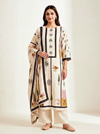 Cream muslin cotton suit set with floral and tree prints, includes kurta, pants, and dupatta by Karchobi.