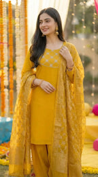 Woman in mustard yellow kurta set with gota lace at Karchobi outdoor event