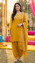 Woman wearing mustard gota lace neck kurta Afghani salwar set from Karchobi outdoors