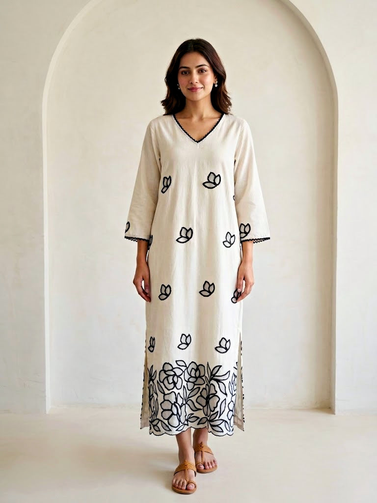 Off-white and black floral applique embroidered kurta dress by Karchobi, featuring intricate embroidery and a long, elegant design.
