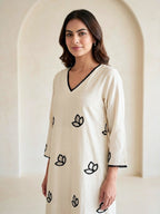 Off-White Karchobi embroidered kurta dress with black floral appliqué and intricate embroidery, stylish long ethnic wear.