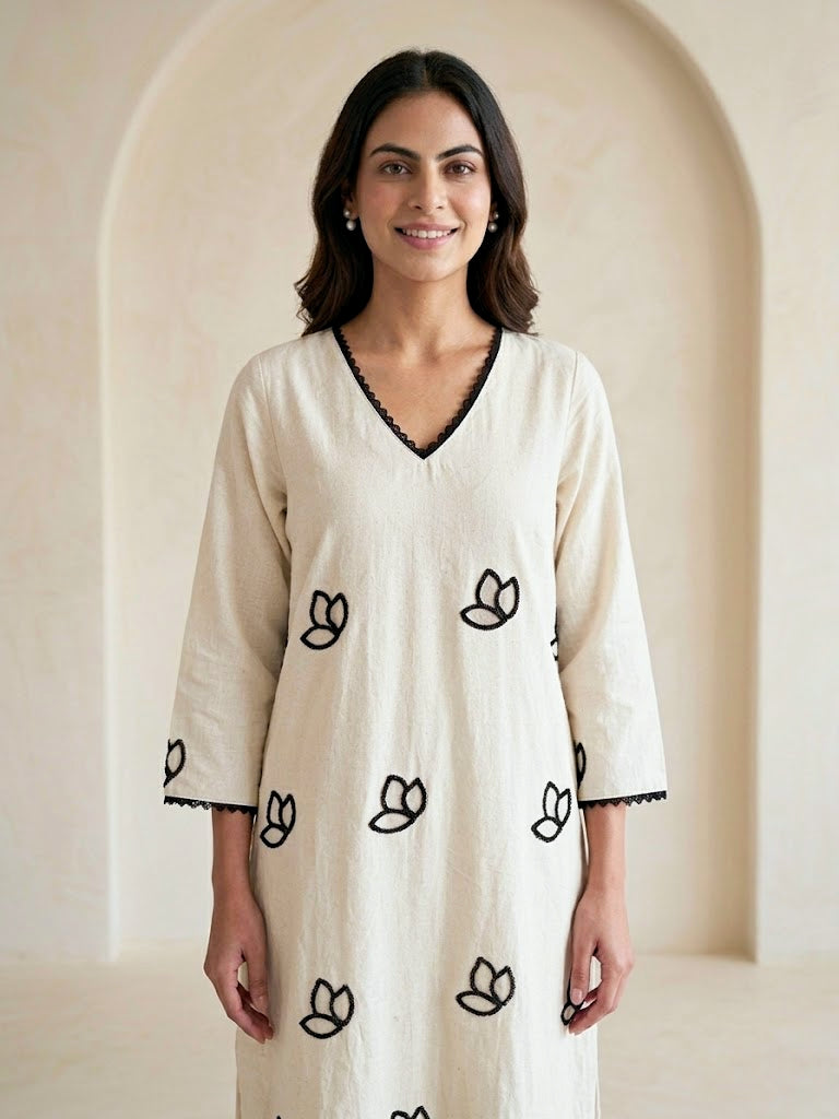 Off-White Karchobi embroidered kurta dress with floral appliqué and embroidery, long black and off-white design.