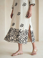 Off-white and black floral applique embroidered kurta dress by Karchobi, featuring intricate embroidery and a long, elegant design.