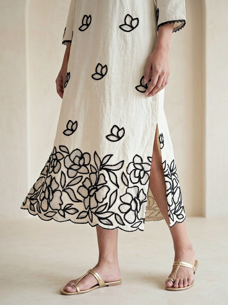 Off-white and black floral applique embroidered kurta dress by Karchobi, featuring intricate embroidery and a long, elegant design.