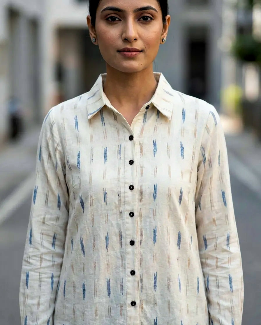 Woman wearing a patterned ikat shirt on a blurred street background