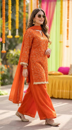 Woman wearing orange floral sequin embroidered kurta sharara lace set from Karchobi