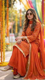 Woman in orange floral sequin embroidered kurta sharara lace set from Karchobi, outdoors