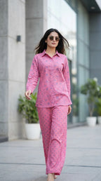 Woman wearing Karchobi pink tropical printed shirt and pant co-ord set outdoors