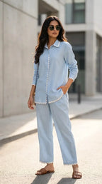 Woman wearing a powder blue scallop lace co-ord set from Karchobi, standing outdoors.
