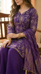 Woman wearing a purple floral sequin embroidered kurta sharara set with matching dupatta from Karchobi