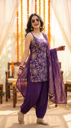 Woman in purple floral sequin embroidered sleeveless kurta with Afghani salwar and dupatta, festive ethnic wear from Karchobi