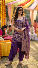 Woman in purple floral sequin embroidered sleeveless kurta with Afghani salwar and dupatta, outdoor festive setting, Karchobi women’s ethnic fashion.